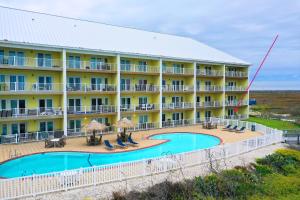 an aerial view of a hotel with a swimming pool at Salt Sun by AvantStay Beach Access Pool in Port Aransas
