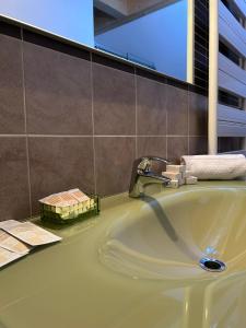 a bathroom with a sink and a tub at Jolly Resort & Spa in Ponte di Legno