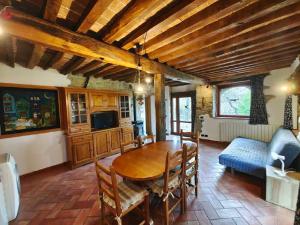 a dining room with a table and a couch at Agriturismo Fattoria Ca Di Sole in San Benedetto Val di Sambro