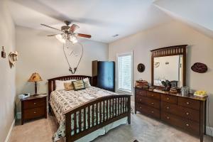 a bedroom with a bed and a ceiling fan at Family Lake House Retreat by AvantStay Sleeps 28 in Mooresville