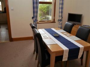 a dining room table with a blue and white table cloth at Number 48 in Dumfries