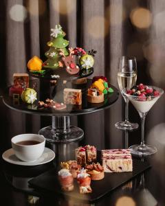 a three tiered tray with different types of food and wine at Four Seasons Hotel Baku in Baku