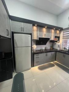 una grande cucina con frigorifero bianco di Casa D JR Homestay a Ipoh