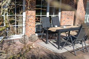 a black table and chairs on a patio at Gosewehr GbR in Hooksiel