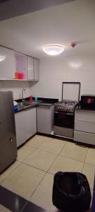 a kitchen with a stove and a sink at Luxurious B in Lagos