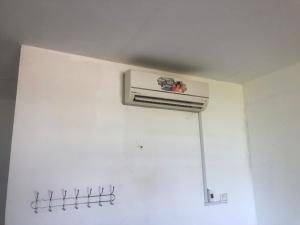 a air conditioner on a white wall in a room at Soksan Natura Beach in Koh Rong Island