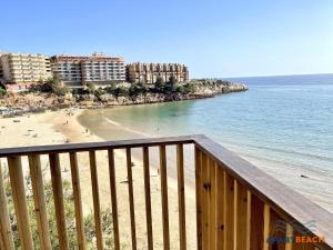 a view of a beach with buildings and the ocean at APARTBEACH EL CARRILET CENTRICO y LUMINOSO in Reus