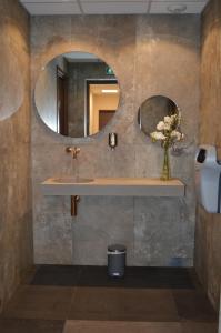 
a bathroom with a sink and a mirror at Hotel Port Toga in Bastia
