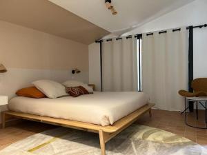 a bedroom with a large bed with a wooden frame at Villa des jacinthes in Tarascon +63 photos