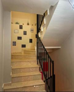 a stairway with wooden steps and a wall with pictures at Daynightsapanca in Sapanca