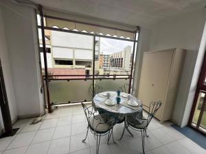 a table and chairs in a room with a large window at Monolocale La Conchiglia in Sestri Levante