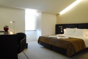 Ένα ή περισσότερα κρεβάτια σε δωμάτιο στο Hotel Jeronimos 8