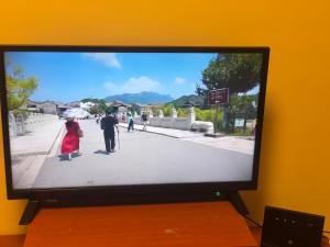 a television screen with a picture of a man and a woman at kvartira in Krāslava