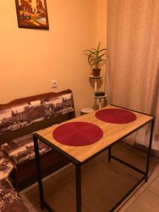 a table with two red mats on it in a room at kvartira in Krāslava