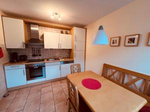 a kitchen with a table and a dining room at Ferienhaus Dirka in Norddeich +1 photo