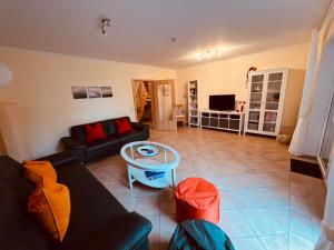 a living room with a couch and a table at Ferienhaus Dirka in Norddeich