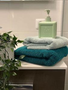 a pile of towels sitting on a counter in a bathroom at Appartement familial 8 personnes proche de Disney et Paris in Chessy