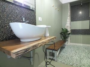 a bathroom with a large white sink on a wooden counter at Città Vecchia in Bitonto +15 photos