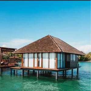a house on a pier in the water at Leebong Island Resort in Leebong