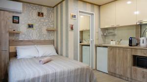 a small kitchen with a bed in a room at Varna Attic Studio in Varna City