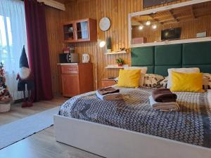 a bedroom with a large bed with yellow pillows at Pokoje gościnne U Paliderki in Poronin