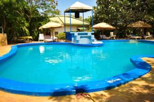 a large swimming pool with blue water in a yard at Seaview Resort Malindi in Malindi