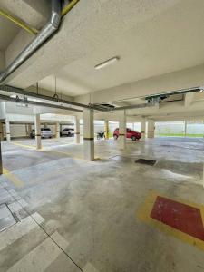 an empty parking garage with a car parked in it at champs frente mar ao sol in Balneário Camboriú