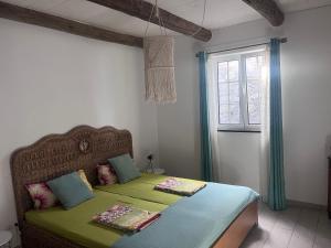 a bedroom with a bed with green sheets and a window at Lucky Lemons - Boutique Houses Madeira - 2 in Estreito da Calheta +19 photos