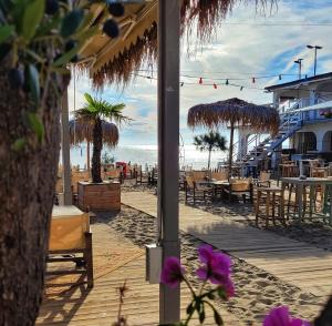 a beach with tables and chairs and the ocean at Varna Attic Studio in Varna City