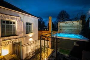 a house with a swimming pool next to a building at Luxury 1 bed Villa - great location - Peaceful-Hot Tub in Bowness-on-Windermere