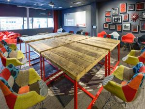 a conference room with a wooden table and chairs at ibis Birmingham Centre New Street Station Hotel in Birmingham