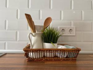a basket with utensils and a plant on a counter at Apartamentos Benal Beach Group in Benalmádena
