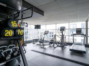 a gym with several treadmills and cardio machines at Novotel Glasgow Centre in Glasgow