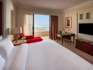 a bedroom with a large bed and a large window at Sofitel Bahrain Zallaq Thalassa Sea & Spa in Manama