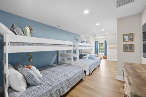 two bunk beds in a room with blue walls at Bright Water Cove by AvantStay Saltwater Pool in Denver