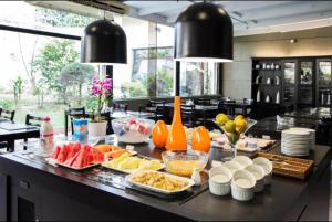 a buffet of food on a counter in a restaurant at You Stay at Vila Olimpia - The World in Sao Paulo