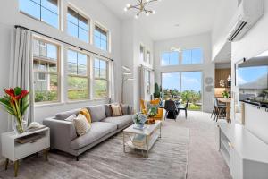 a living room with a couch and a table at Lealea by AvantStay Ocean Mountain Views in Waianae