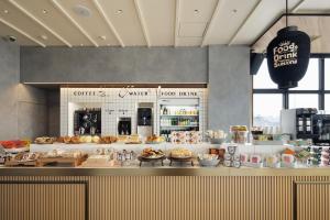a bakery with a counter with food on it at OMO3 Asakusa by Hoshino Resorts in Tokyo