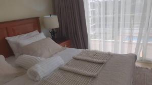 Cama o camas de una habitación en Kawe Lux Poolside Apartment