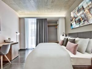 a hotel room with a large bed and a couch at Number 11 St Julian's Malta - Handwritten Collection in St. Julianʼs