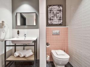 a bathroom with a sink and a toilet at Number 11 St Julian's Malta - Handwritten Collection in St. Julianʼs