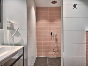 a bathroom with a shower with pink tiles at Number 11 St Julian's Malta - Handwritten Collection in St. Julianʼs