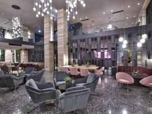 a lobby of a hotel with chairs and tables at Number 11 St Julian's Malta - Handwritten Collection in St. Julianʼs