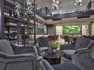 a restaurant with chairs and tables and a bar at Number 11 St Julian's Malta - Handwritten Collection in St. Julianʼs