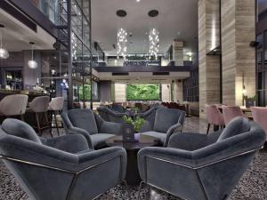 a lobby with chairs and a table and a bar at Number 11 St Julian's Malta - Handwritten Collection in St. Julianʼs