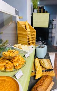 a table with bread and other food items on it at Hotel & Spa Gil de France Cap d'Agde in Cap d'Agde