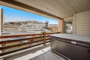 a balcony with a hot tub and a view at Mont Cervin 21 by AvantStay Luxury Ski in Ski out home in Park City in Park City