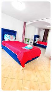 a bedroom with a bed with a red blanket on it at Cosy Duplex" Sidi Bou Said " in Sidi Bou Saïd