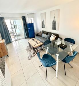 a living room with a glass table and a couch at Cosmopolitan by Lovely Property in Corralejo