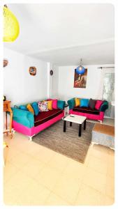 a living room with two couches and a coffee table at Cosy Duplex" Sidi Bou Said " in Sidi Bou Saïd